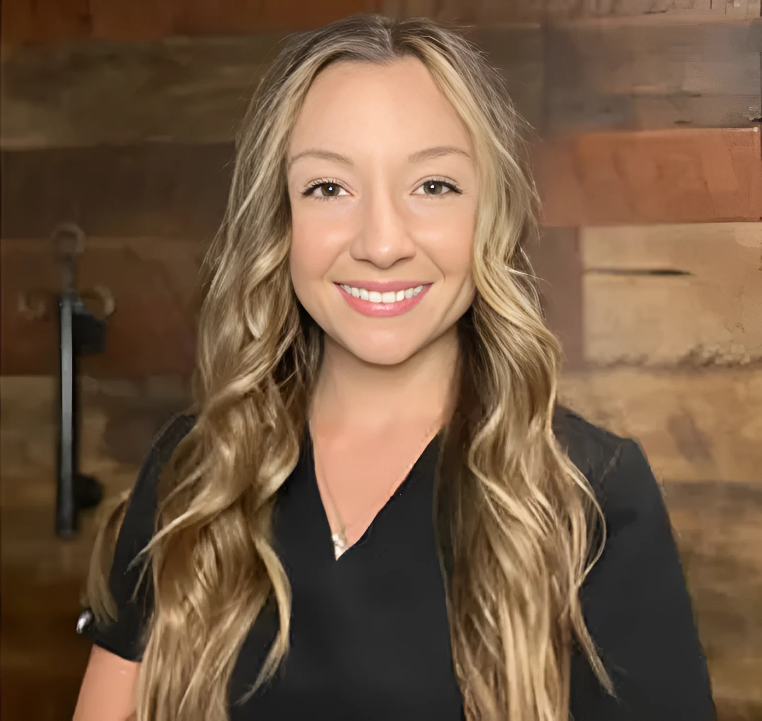 Smiling woman with long blonde hair.