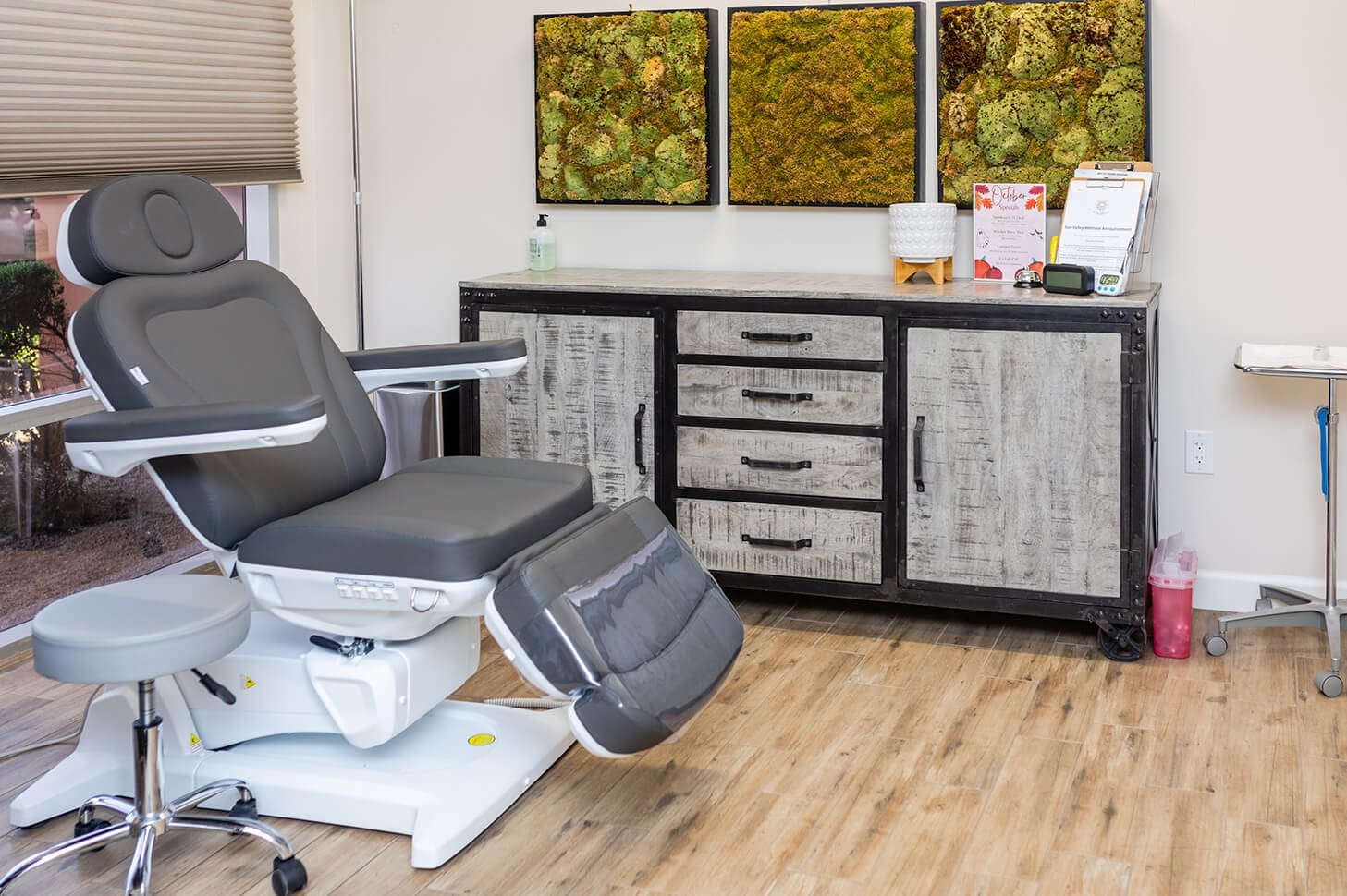 Medical exam room with chair and table.